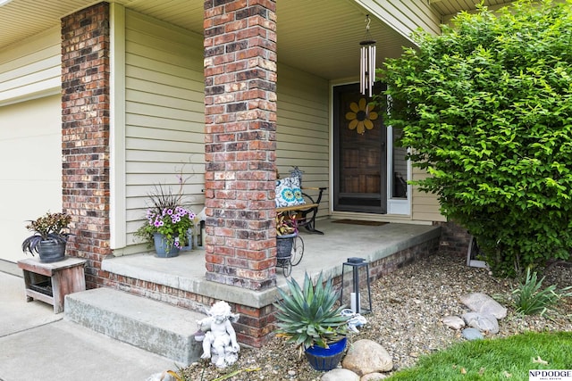 13952 Frederick Cir, Omaha, NE 68138 - property entrance with covered porch and a garage