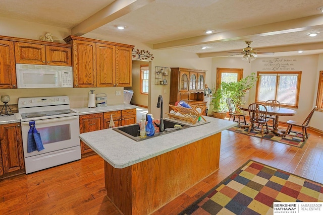 5531 County Road 34, Fort Calhoun, NE 68023 - kitchen with white appliances, a sink, light countertops, beam ceiling, and ceiling fan