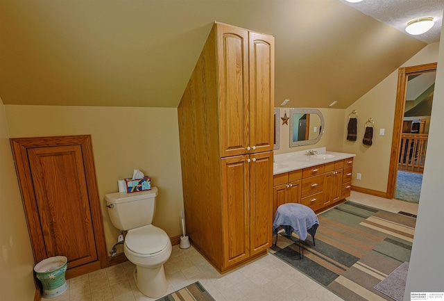 5531 County Road 34, Fort Calhoun, NE 68023 - bathroom with lofted ceiling, vanity, toilet, and baseboards
