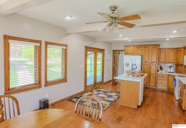 5531 County Road 34, Fort Calhoun, NE 68023 - kitchen featuring white appliances, light countertops, a kitchen island with sink, light wood-style flooring, and recessed lighting