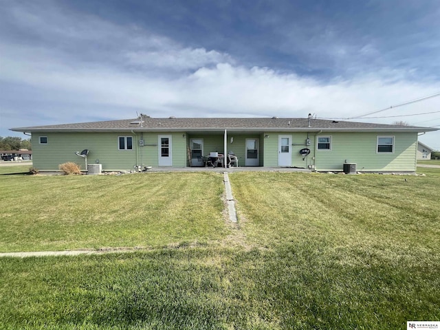 901 E 9th St, Valentine, NE 69201 - back of house featuring central AC unit, a lawn, and a patio