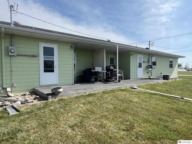 901 E 9th St, Valentine, NE 69201 - rear view of house featuring a yard, a patio, and cooling unit