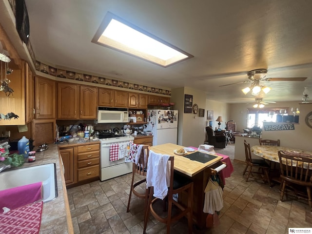 901 E 9th St, Valentine, NE 69201 - kitchen featuring white appliances, stone finish floors, light countertops, and a sink