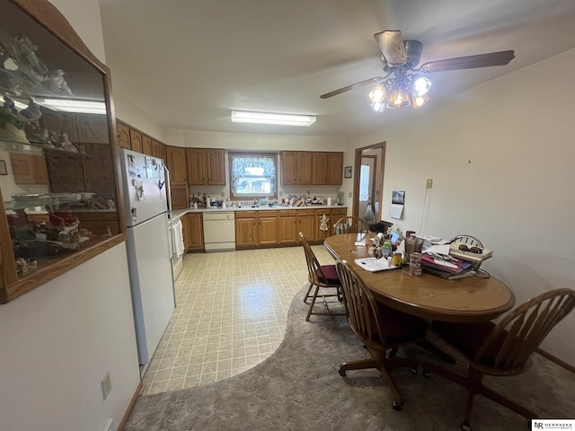 901 E 9th St, Valentine, NE 69201 - kitchen featuring white appliances, ceiling fan, light countertops, a sink, and light flooring