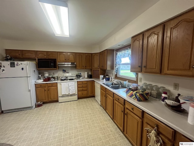 901 E 9th St, Valentine, NE 69201 - kitchen featuring white appliances, under cabinet range hood, a sink, light countertops, and brown cabinets