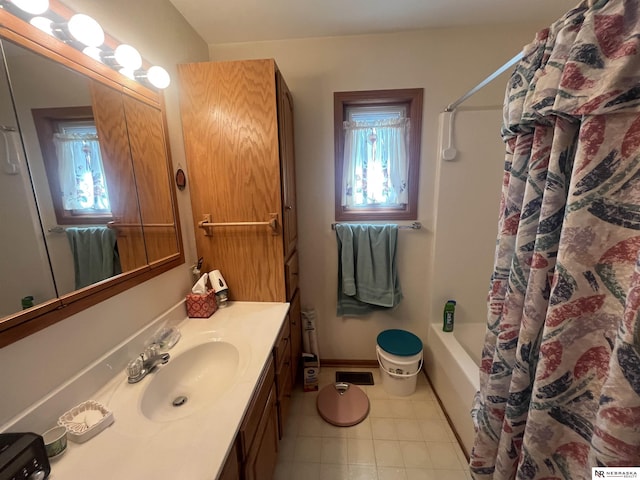 901 E 9th St, Valentine, NE 69201 - bathroom featuring vanity, tile patterned floors, and shower / bathtub combination with curtain