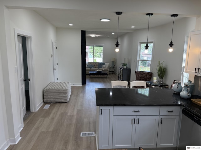914 S 26th St, Omaha, NE 68105 - kitchen featuring stainless steel dishwasher, a peninsula, light wood-style floors, open floor plan, and white cabinetry