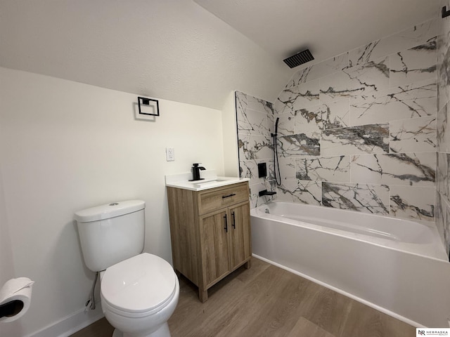 914 S 26th St, Omaha, NE 68105 - bathroom with wood finished floors, a combined bath / shower with rainfall shower, vanity, toilet, and vaulted ceiling