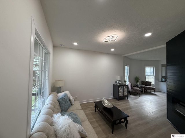 914 S 26th St, Omaha, NE 68105 - living room with recessed lighting, a desk, a textured ceiling, wood finished floors, and baseboards