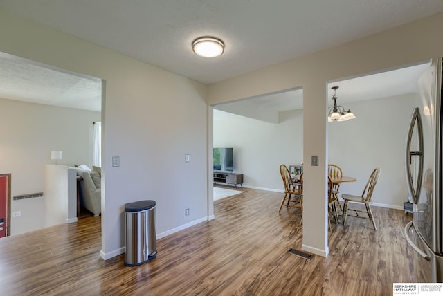 14014 S 35th St, Bellevue, NE 68123 - dining area with wood finished floors, a chandelier, and baseboards