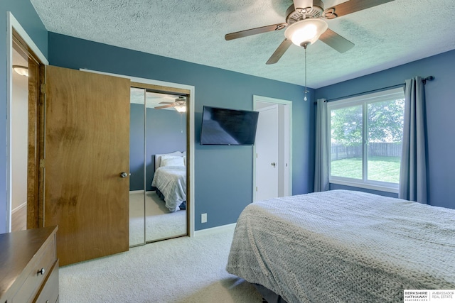 14014 S 35th St, Bellevue, NE 68123 - carpeted bedroom with a textured ceiling, a ceiling fan, two closets, and baseboards