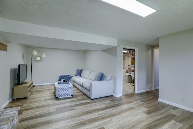 14014 S 35th St, Bellevue, NE 68123 - living room with light wood finished floors, baseboards, and a textured ceiling