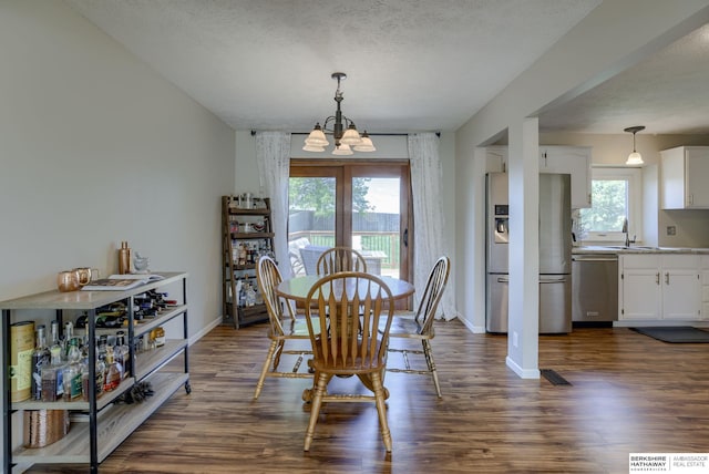 14014 S 35th St, Bellevue, NE 68123 - dining room with a chandelier, dark wood-type flooring, baseboards, and a textured ceiling