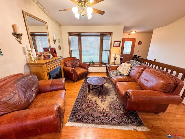 1507 SW 13th St, Lincoln, NE 68522 - living room featuring wood finished floors, a ceiling fan, healthy amount of natural light, and a fireplace