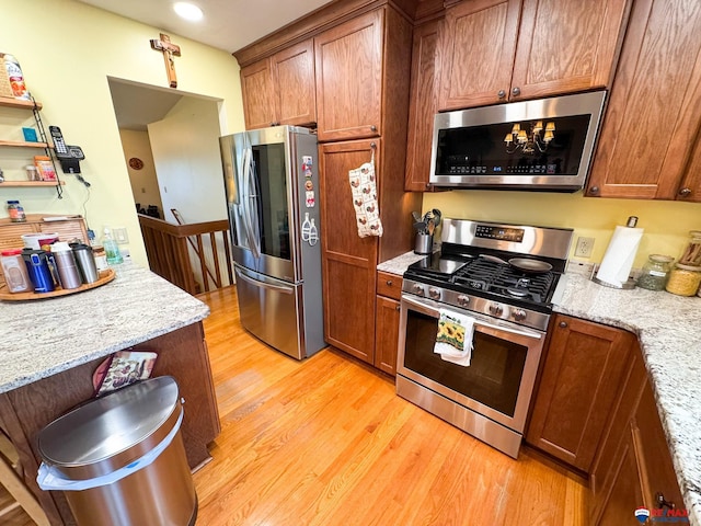 1507 SW 13th St, Lincoln, NE 68522 - kitchen featuring stainless steel appliances, light wood finished floors, brown cabinets, light stone countertops, and recessed lighting