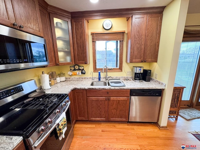 1507 SW 13th St, Lincoln, NE 68522 - kitchen with stainless steel appliances, a sink, light wood finished floors, and healthy amount of natural light