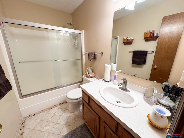 1507 SW 13th St, Lincoln, NE 68522 - full bath featuring vanity, bath / shower combo with glass door, toilet, and tile patterned flooring