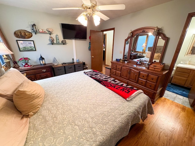1507 SW 13th St, Lincoln, NE 68522 - bedroom with light wood-type flooring, ensuite bath, and ceiling fan