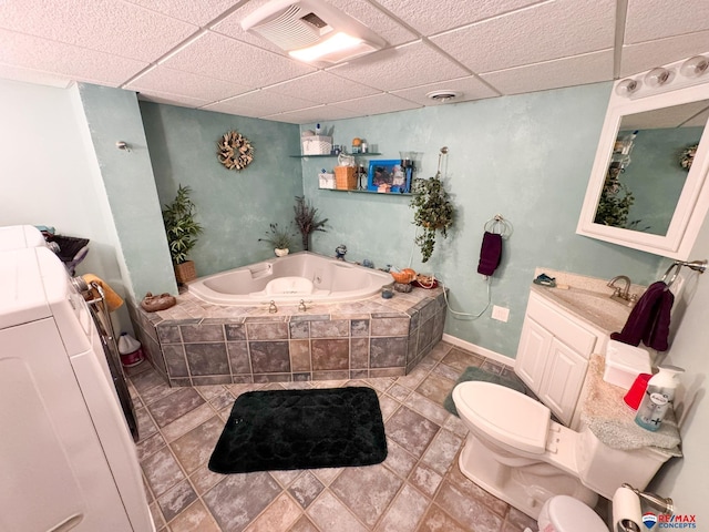 1507 SW 13th St, Lincoln, NE 68522 - full bathroom featuring toilet, a bath, washer / dryer, vanity, and a paneled ceiling
