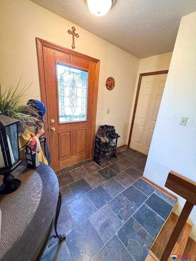 1507 SW 13th St, Lincoln, NE 68522 - foyer entrance with a textured ceiling, baseboards, and stone tile flooring
