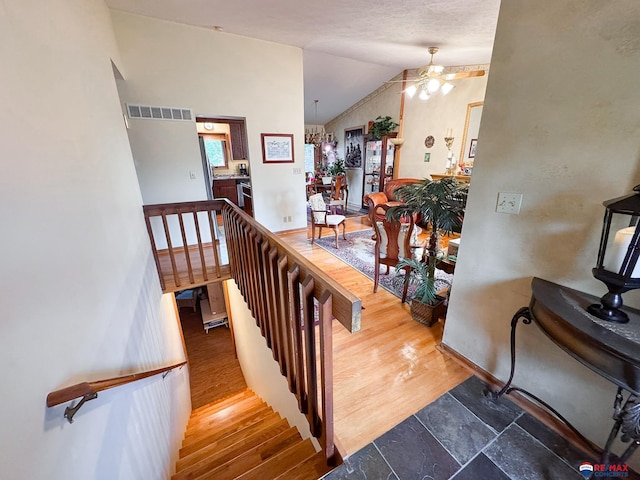 1507 SW 13th St, Lincoln, NE 68522 - stairway featuring ceiling fan, vaulted ceiling, and baseboards