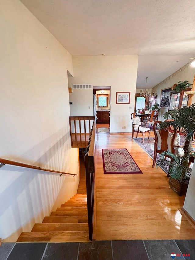 1507 SW 13th St, Lincoln, NE 68522 - stairs with wood finished floors and a chandelier