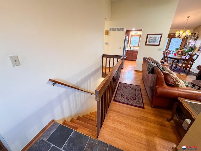 1507 SW 13th St, Lincoln, NE 68522 - staircase with wood finished floors and a chandelier