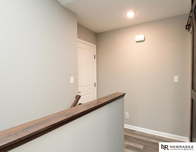 4062 W Gary Gately St, Lincoln, NE 68528 - corridor with an upstairs landing, wood finished floors, recessed lighting, a barn door, and baseboards