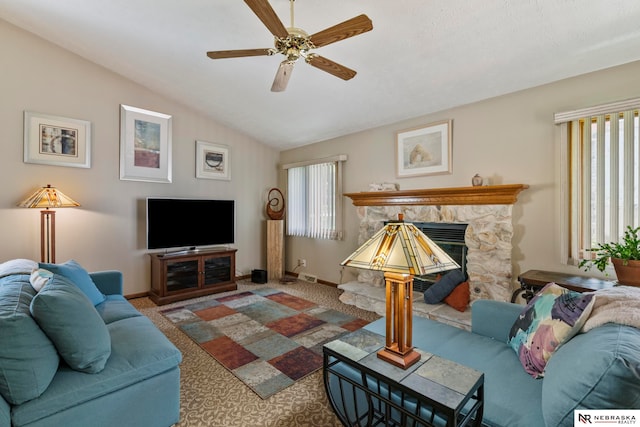 5082 S 149th Ct, Omaha, NE 68137 - living area featuring a ceiling fan, carpet floors, baseboards, a stone fireplace, and vaulted ceiling