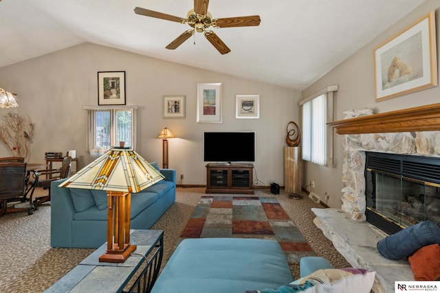 5082 S 149th Ct, Omaha, NE 68137 - living room with carpet floors, vaulted ceiling, ceiling fan, a stone fireplace, and baseboards