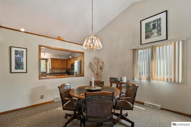 5082 S 149th Ct, Omaha, NE 68137 - carpeted dining room featuring vaulted ceiling, a chandelier, and baseboards