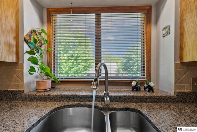 5082 S 149th Ct, Omaha, NE 68137 - kitchen view of a sink, backsplash, and dark stone counters