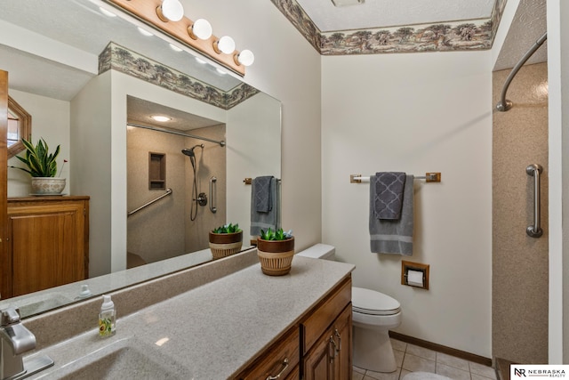 5082 S 149th Ct, Omaha, NE 68137 - bathroom with a shower, tile patterned flooring, toilet, vanity, and baseboards