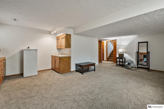 5082 S 149th Ct, Omaha, NE 68137 - finished below grade area with light carpet, baseboards, a textured ceiling, stairs, and a sink