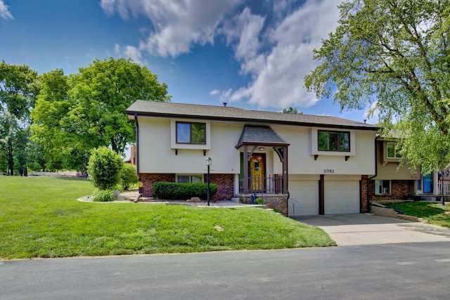 5082 S 149th Ct, Omaha, NE 68137 - bi-level home featuring a garage, brick siding, a front lawn, and driveway