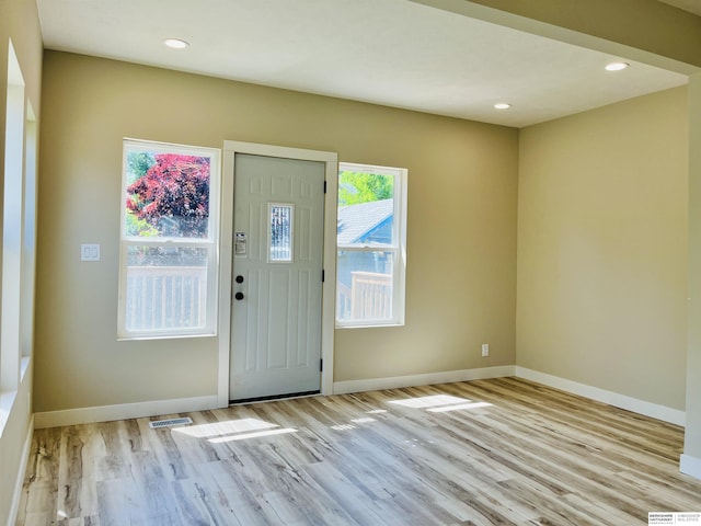 6916 N 24th St, Omaha, NE 68112 - entryway with wood finished floors, baseboards, and recessed lighting