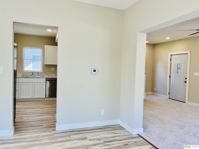 6916 N 24th St, Omaha, NE 68112 - unfurnished room with light wood-type flooring, baseboards, recessed lighting, a ceiling fan, and a sink