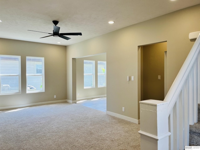 6916 N 24th St, Omaha, NE 68112 - spare room with light carpet, healthy amount of natural light, ceiling fan, recessed lighting, and baseboards