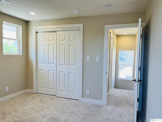 6916 N 24th St, Omaha, NE 68112 - unfurnished bedroom with carpet, a closet, baseboards, and recessed lighting