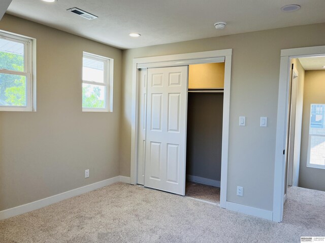 6916 N 24th St, Omaha, NE 68112 - unfurnished bedroom with carpet, baseboards, a closet, and recessed lighting