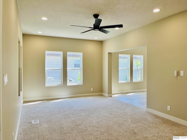 6916 N 24th St, Omaha, NE 68112 - empty room with carpet, healthy amount of natural light, recessed lighting, ceiling fan, and baseboards