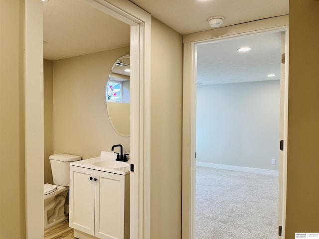 6916 N 24th St, Omaha, NE 68112 - bathroom featuring vanity, toilet, and recessed lighting