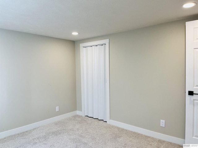 6916 N 24th St, Omaha, NE 68112 - spare room featuring recessed lighting, light carpet, and baseboards