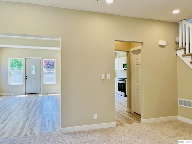 6916 N 24th St, Omaha, NE 68112 - unfurnished room with stairs, baseboards, recessed lighting, and light colored carpet