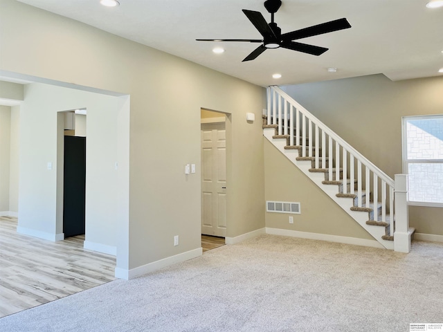 6916 N 24th St, Omaha, NE 68112 - unfurnished living room with stairway, recessed lighting, carpet floors, ceiling fan, and baseboards
