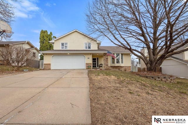 926 Iron Rd, Papillion, NE 68046 - view of front of house with brick siding, driveway, and a garage
