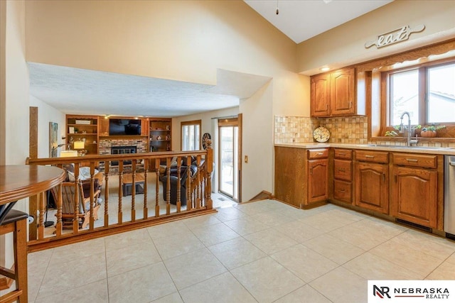 926 Iron Rd, Papillion, NE 68046 - kitchen with a sink, light countertops, open floor plan, a fireplace, and plenty of natural light