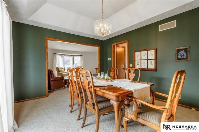 926 Iron Rd, Papillion, NE 68046 - dining space with a chandelier, light colored carpet, and baseboards