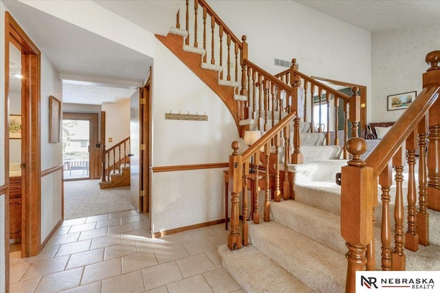 926 Iron Rd, Papillion, NE 68046 - staircase featuring carpet flooring, tile patterned floors, and baseboards