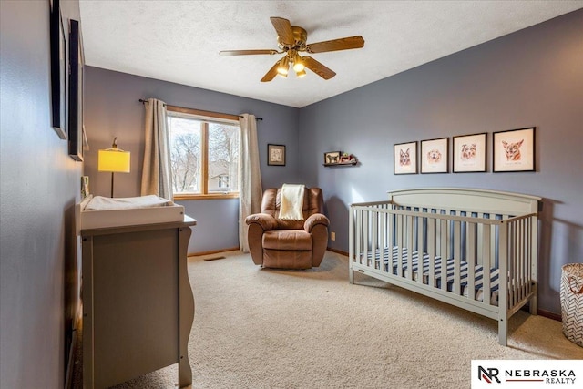 926 Iron Rd, Papillion, NE 68046 - bedroom with carpet floors, a crib, baseboards, and ceiling fan